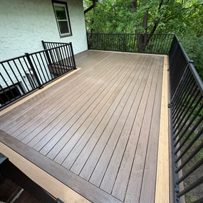 Custom composite deck with black metal railing installed at a Ramsey, MN home