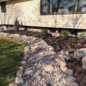 Natural stone dry creek bed for landscape drainage in Anoka, MN