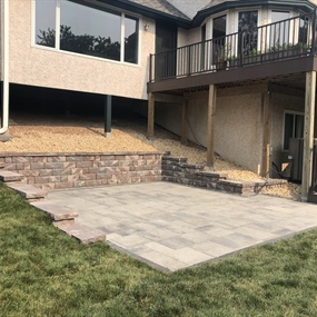 Paver patio installation beneath elevated deck in Maple Grove, MN